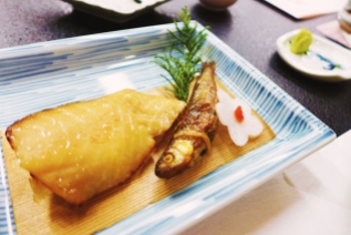 Grilled fish, a chunk and a whole (plus a daikon flower)